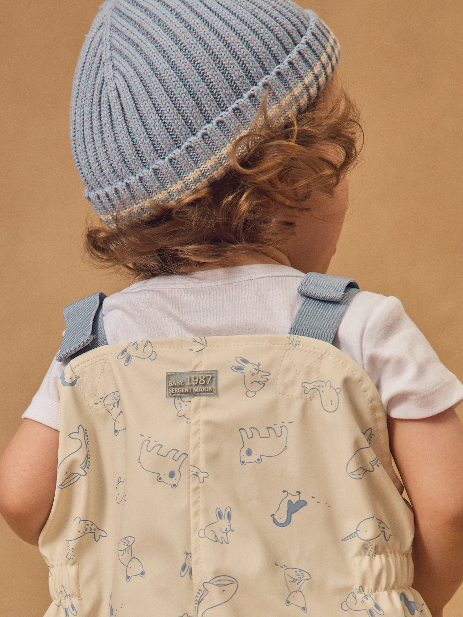 Salopette da pioggia ecru con stampa animale per neonato maschio - Image 3